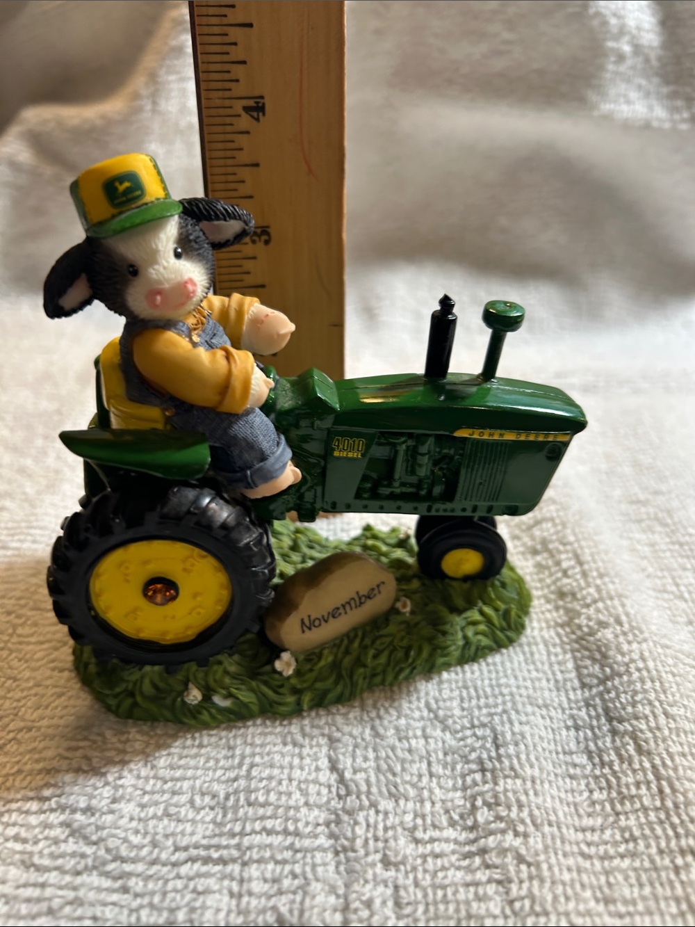 Mary moo Cow Figurine on Green John Deere Tractor - November